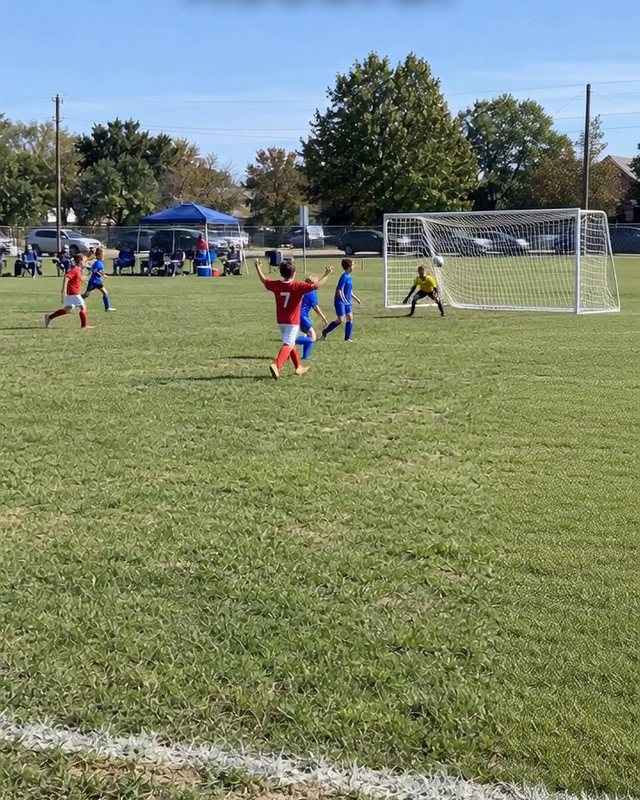 A child shoots at goal